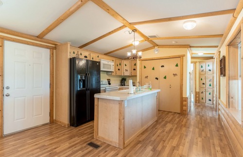 Polson House | Inviting lake view home with fireplace, golf nearby, full kitchen, & W/D