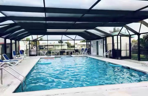 Flamingo Bay House | ISLAND TIME! DOCK! POOL! KAYAKS! BOAT To BEACH! PETS ALLOWED! The Purple House
