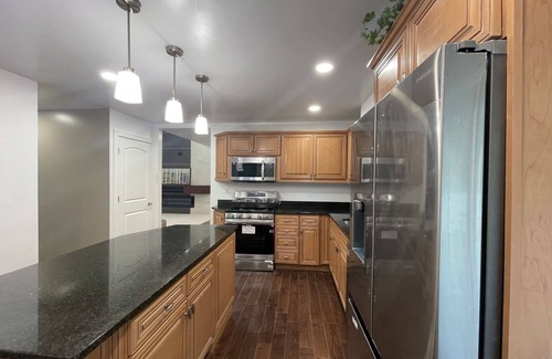 Racine House | Lake Michigan Retreat. Spacious 4-bedroom home on wooded lot across from lake.