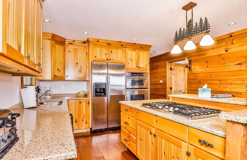 Manitowish Waters Condo | Lakefront home with large deck, gas grill, wood fireplace, heated pool, firepit
