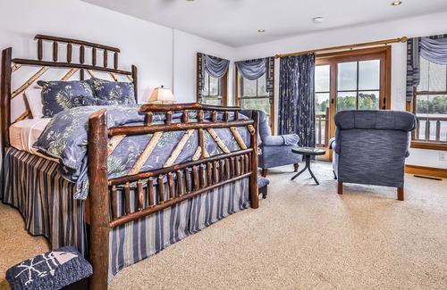 Manitowish Waters Condo | Lakefront home with large deck, gas grill, wood fireplace, heated pool, firepit