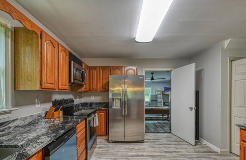Bumpass House | Lakefront home with spacious deck, dock, game room, hot tub, & sunset views