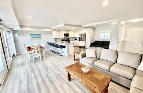 Rehoboth Beach Condo | LINENS & DAILY ACTIVITIES INCLUDED! OCEANFRONT/BOARDWALK BUILDING W/ROOFTOP POOL Completely remodeled kitchen with all-new cabinets and appliances, open floor plan and eat-at counter.
