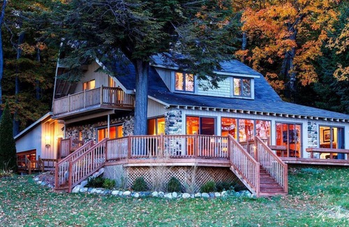 Suttons Bay House | Lodge-style home in Suttons Bay. Main house & caboose. Central A/C. Pet ok.