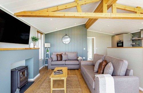 Middlezoy Ski Chalet | Luxurious lodge with vaulted ceilings and a welcoming feature fireplace.