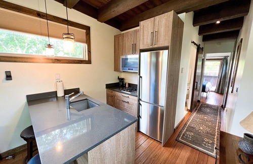 Montrose House | Luxury Accommodation. Bedroom with queen bed. Sleeper sofa in living area. Full bath with shower. Kitchen. Living area with TV and Fireplace. Washer/Dryer.