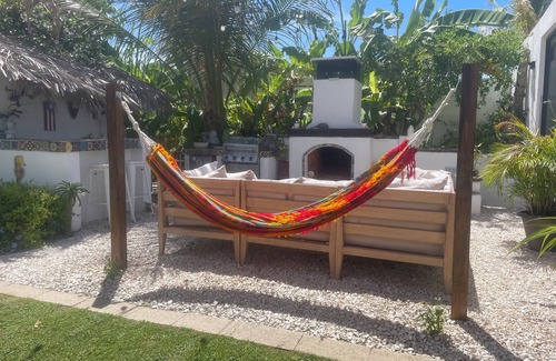 Bajo House | Malecon Beach House with beautiful backyard. Steps from the Caribbean ocean.