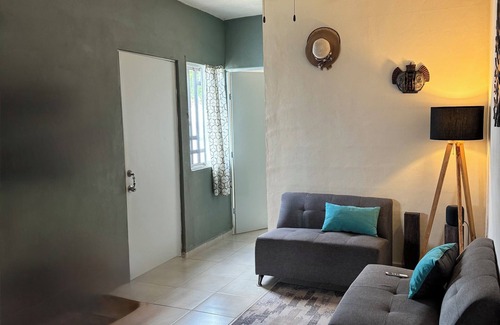 Cancun House | MiniHouse in front of park with parking.