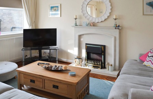 Beadnell Cottage | Modern accommodation with sun room and patio overlooking a small lake.