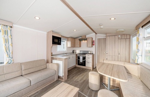 Otterton House | Modern and spacious 12ft-wide caravan with one double and two twin.
