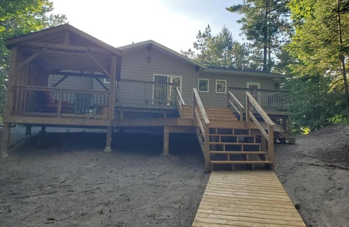 Wymbolwood Beach Cottage | Near Sandy Beach, Comfy Cottage - Multi leveled Deck with Woodland Backdrop