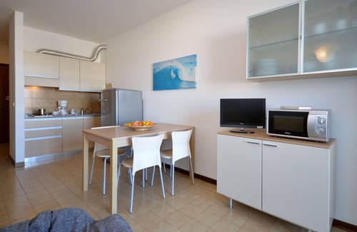 Lignano Sabbiadoro Apartment | Nice apartment for 4 guests with pool, A/C, TV, terrace and pets allowed
