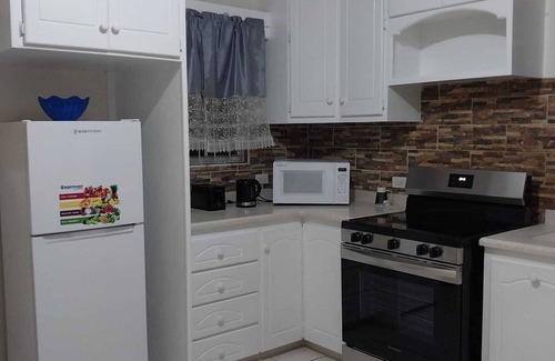 Below Rock Apartment | Oistins 2 Bed Apartment with AC Near Miami Beach & Oistins.