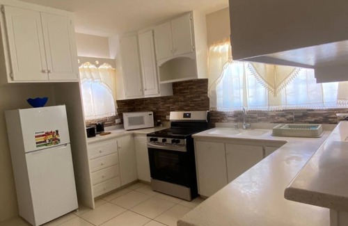 Below Rock Apartment | Oistins 2 Bed Apartment with AC Near Miami Beach & Oistins.