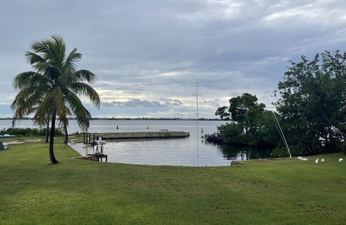 Little Torch Key House | Old Florida Style, wrap around porch, boat basin for dockage, open water