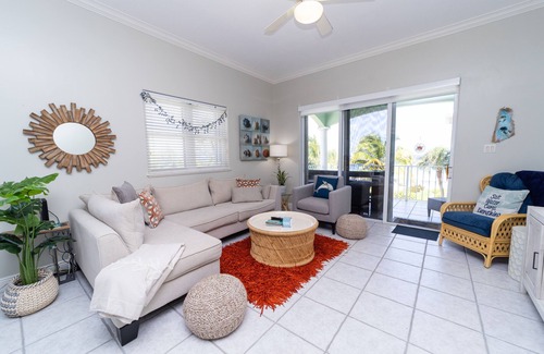 Old Man Bay Condo | On The Bay 312 is located on a white sandy beach in the quaint Old Man Bay.