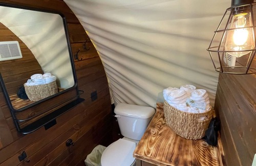 Branson Cottage | Oregon Trail Wagon has two queens size bed, bathroom w/shower, heat & a/c, smart tv, wi-fi, microwa