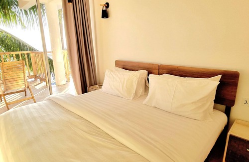 Thulusdhoo Island Hotel | Overlooking ocean that meets cloudless sky, Coral Inn is a sanctuary of serenity