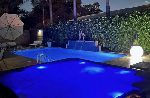 Poinsettia Heights Villa | Palms Retreat! Giant Heated Pool-HotTub-FirePit-5Min2Beach-Pets-EV Chgr