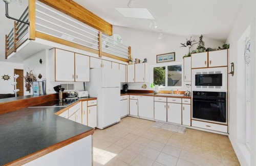 Cape Meares Cottage | Peaceful 4BR Cape Meares Home | Ocean Views, Forest Setting, Wraparound Deck + King Bed