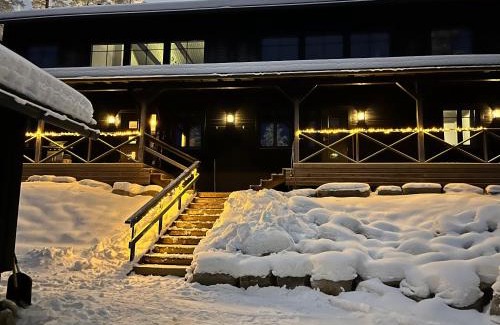 Pyhatunturi Ski Chalet | Porthos Ski-in Lodge with private hot tub and sauna in Lapland