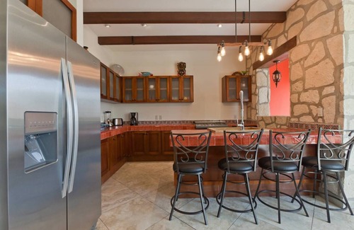 Villa Juarez Condo | Relax to the sound of a waterfall right outside your window!