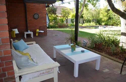 Die Boord House | Retro Red Stone Villa with pool & lush garden