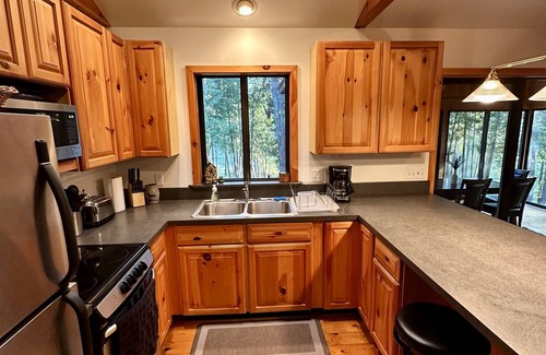 Rapid City Cabin | Riverside Cabin Near Torch Lake – Kayaks Included!