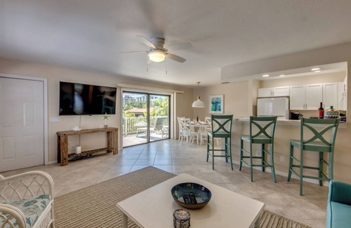 South Island House | Sand Dollar #3 - Upstairs Apt with Shared Pool on Canal by the Beach!