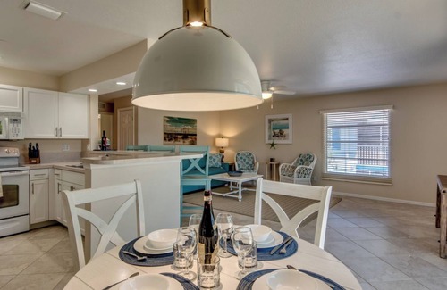 South Island House | Sand Dollar #3 - Upstairs Apt with Shared Pool on Canal by the Beach!