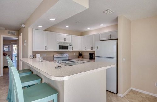 South Island House | Sand Dollar #4 - Upstairs Apt with shared Pool on Canal by the Beach!