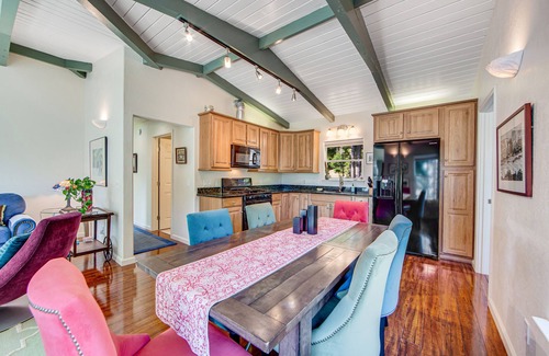 Gualala House | Serene guest suite with shared hot tub, forest views, & splashes of color