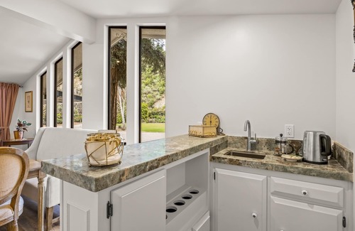 Fillmore House | Single-level home surrounded by lush gardens with a washer/dryer, AC, & wet bar