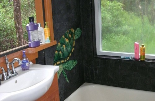 Orchidlands Estates Cottage | Solar powered bohemian loft cottage with birds, lizards, and frogs