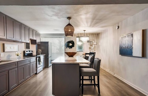 Old East Dallas Condo | Sophisticated 2-Bed, 1.5-Bath furnished condo in central Dallas with a private patio, serene garden views, and exclusive access to an award-winning courtyard equipped with premium wellness products and relaxing lounge areas.