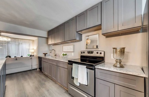 Old East Dallas Condo | Sophisticated 2-Bed, 1.5-Bath furnished condo in central Dallas with a private patio, serene garden views, and exclusive access to an award-winning courtyard equipped with premium wellness products and relaxing lounge areas.