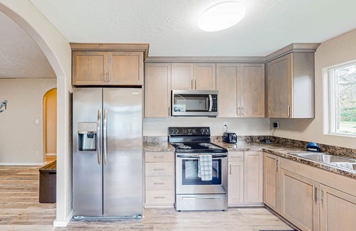 Coos Bay House | Spacious coastal property with separate living quarters, wood stove, & grill
