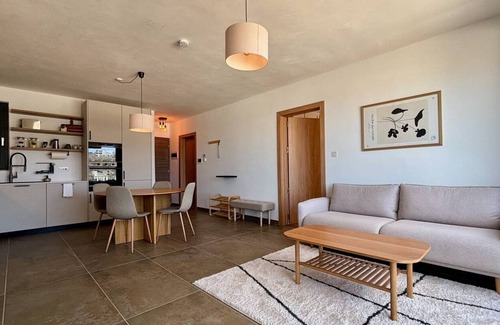 Mellieħa Heights Apartment | Step inside to discover a modern and elegantly decorated space, featuring two spacious bedrooms with ample storage, ensuring a restful and convenient stay. The open-plan living area boasts contemporary furnishings, providing a chic and cozy atmospher