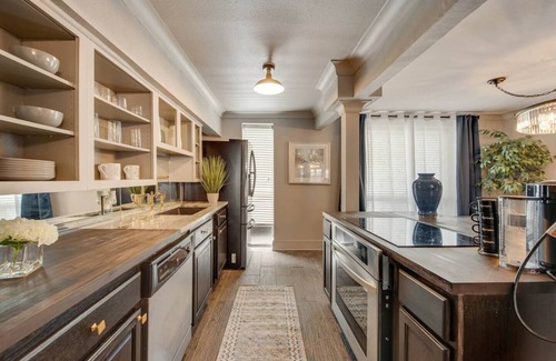 Lower Greenville Condo | Stylish 2BR condo with pool view, cinematic 77” TV, leather sofa, and access to award-winning courtyard retreat.