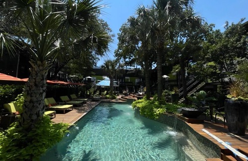 Lower Greenville Condo | Stylish 2BR condo with pool view, cinematic 77” TV, leather sofa, and access to award-winning courtyard retreat.