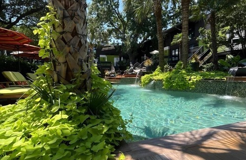 Lower Greenville Condo | Stylish 2BR condo with pool view, cinematic 77” TV, leather sofa, and access to award-winning courtyard retreat.