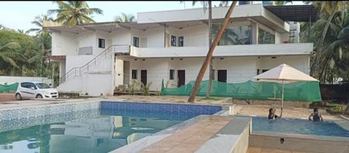 Malpe House | Swimming pool beach front resort