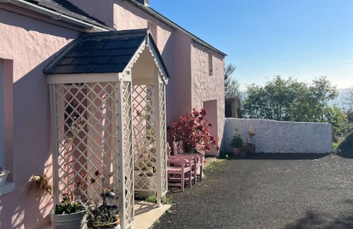 Carrickfergus Cottage | The Pink Cottage Upstairs Suite and Secret Garden. beautiful walks & sea view.