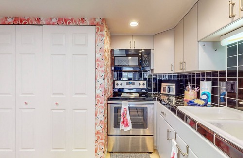 Cocoa Beach Condo | Tropical condo with pool, central AC and private beach access