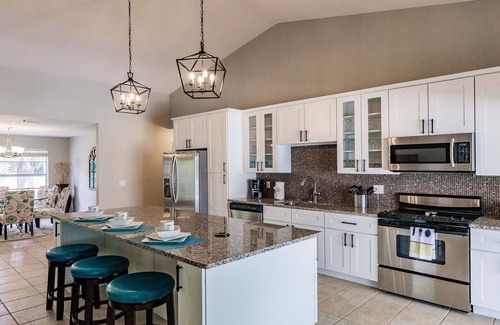 Cape Coral Villa | Villa Coral Cove heated pool, large lanai, lounge and fire pit in For Mile Cove