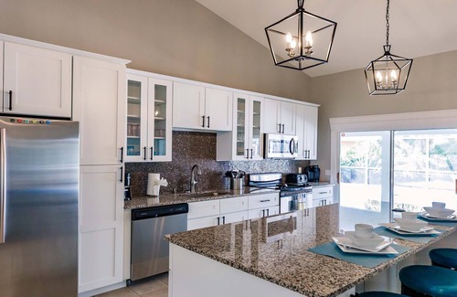 Cape Coral Villa | Villa Coral Cove heated pool, large lanai, lounge and fire pit in For Mile Cove