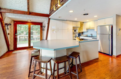 Barnstead House | Waterfront home with wraparound deck, floating fireplace, deck, & firepit