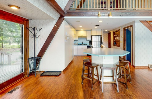 Barnstead House | Waterfront home with wraparound deck, floating fireplace, deck, & firepit