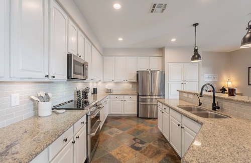 Augusta Ranch House | Welcome to The Shandy Landing! This retreat boasts an amazing new outdoor kitchen, 4 luxury King Bed -Bedrooms, gorgeous privacy, pool & hot tub, lawn games and stunning golf course views. Your serene getaway awaits 🌞⛳