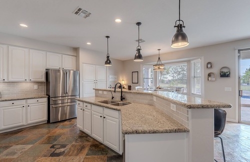 Augusta Ranch House | Welcome to The Shandy Landing! This retreat boasts an amazing new outdoor kitchen, 4 luxury King Bed -Bedrooms, gorgeous privacy, pool & hot tub, lawn games and stunning golf course views. Your serene getaway awaits 🌞⛳